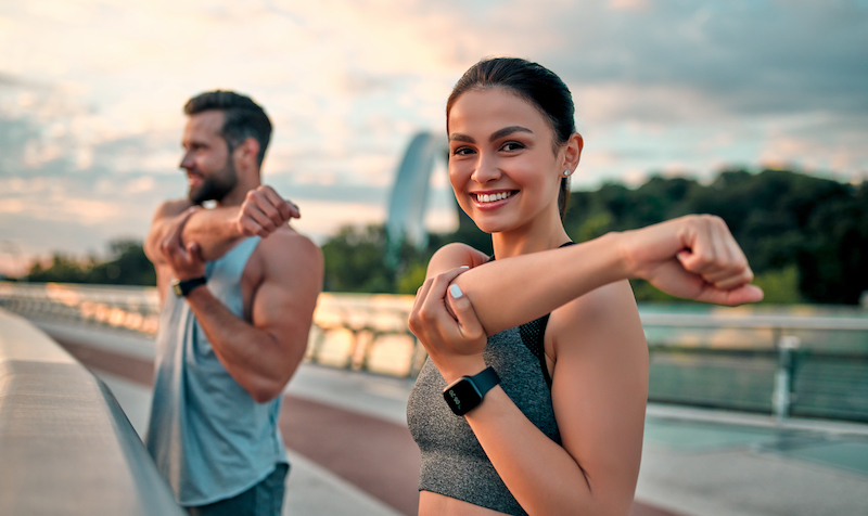 Man and Woman Stretching in Nature
