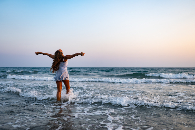 Woman Feeling Free and Content on the Beach