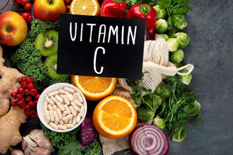 Foods high in vitamin C on dark background. 