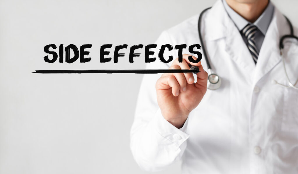 Doctor with marker writing the text "side effects"