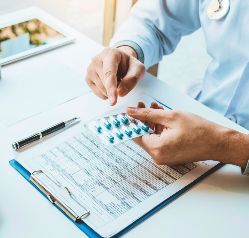 Doctor examining medication on clipboard
