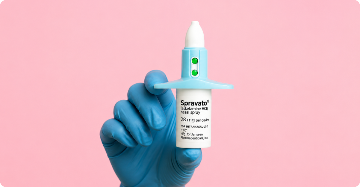 Hand holding nasal spray on pink background