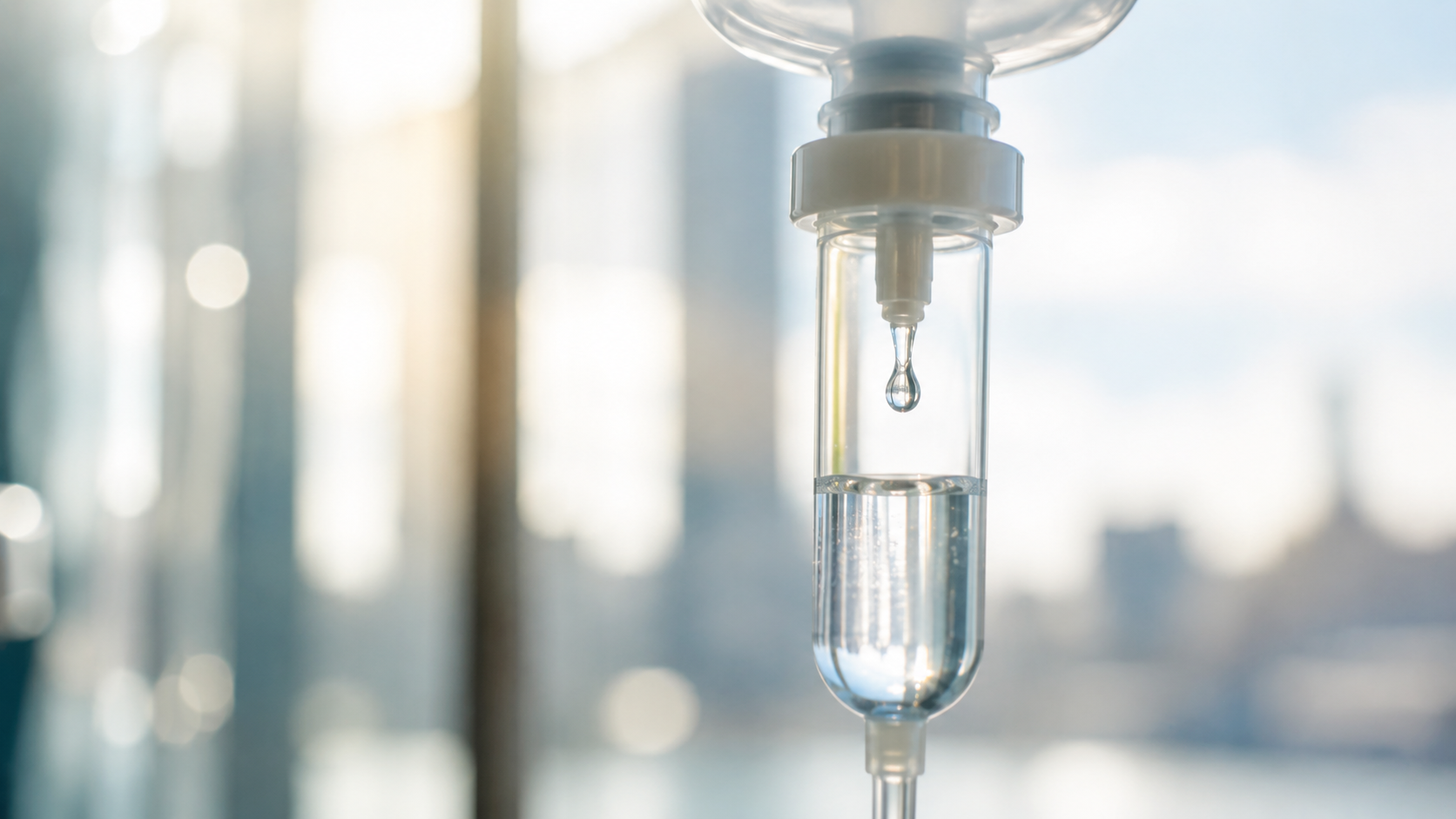 Close-up of an IV drip chamber delivering NAD+ infusion therapy.