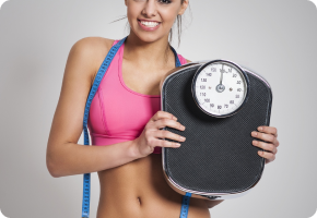 Smiling woman holding a scale